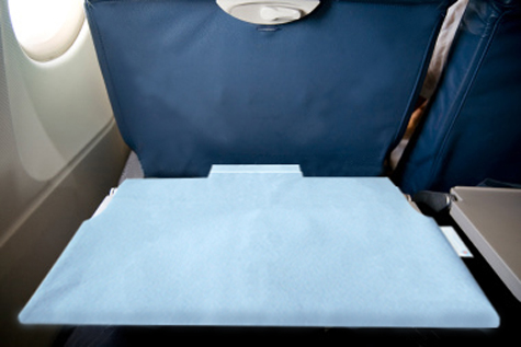 trayGUARD+ environmentally friendly antimicrobial tray table cover for personal use on airplanes, trains and buses